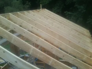 New roof rafters set over an addition before sheathing in Berkeley Springs