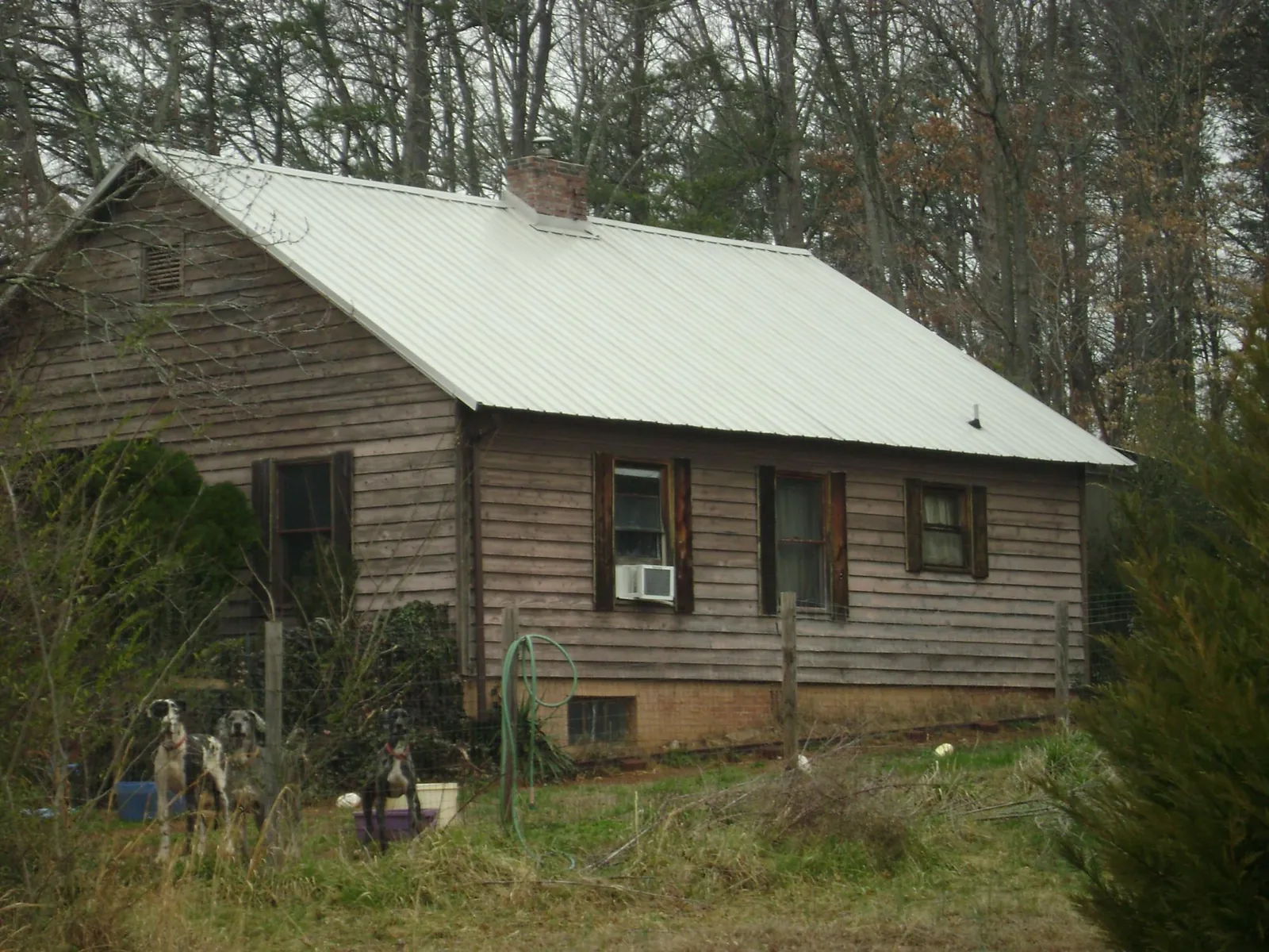 White metal roof on an old wood sided farmhouse, from a Metal Roof Installation job in Berkeley Springs